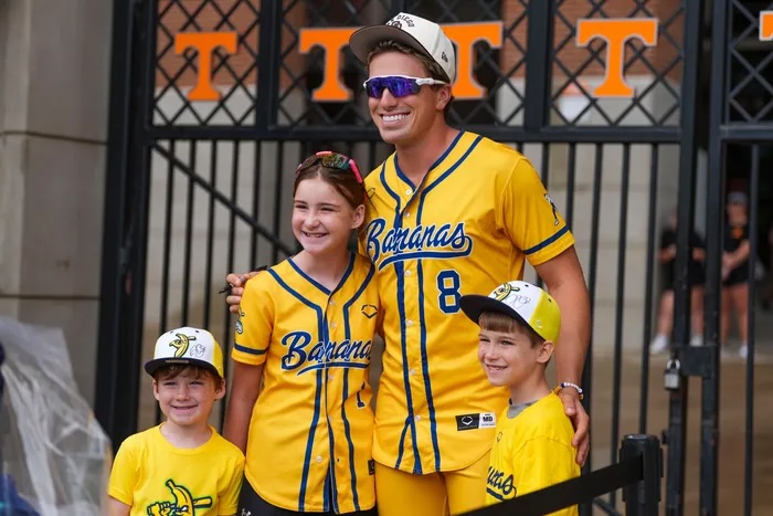 Jackson Olson from the Savannah Bananas posing for a picture with young fans.